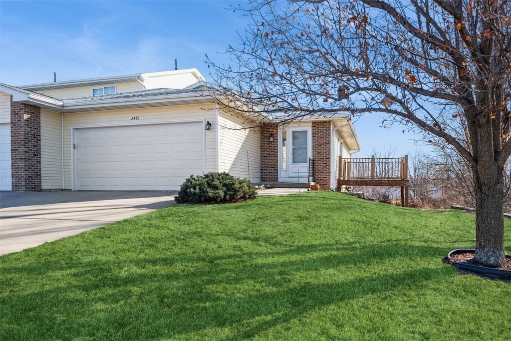 single story home featuring a front yard and a garage