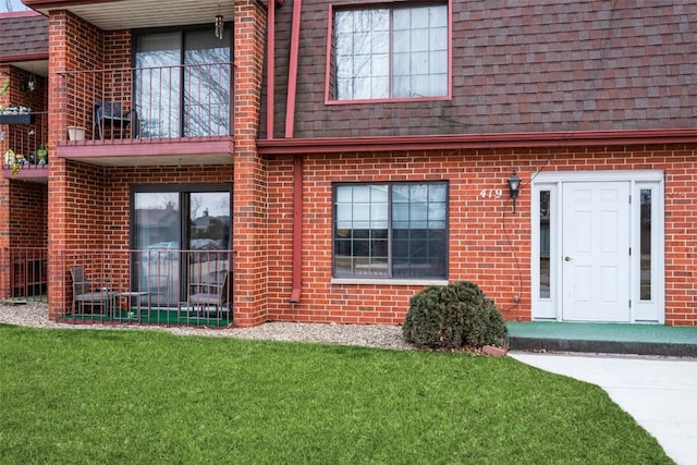 view of exterior entry with a lawn