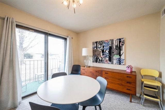 dining space with light colored carpet