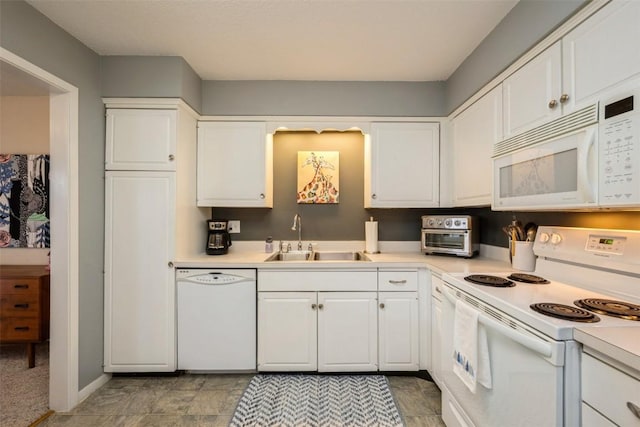 kitchen with sink, white appliances, and white cabinets