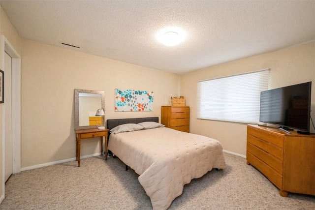 carpeted bedroom featuring a textured ceiling