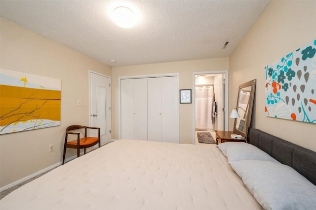 bedroom featuring a textured ceiling, a closet, and connected bathroom