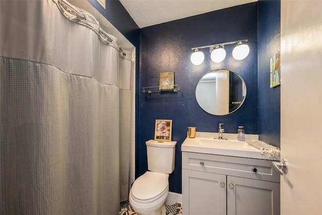 bathroom featuring toilet, walk in shower, and vanity