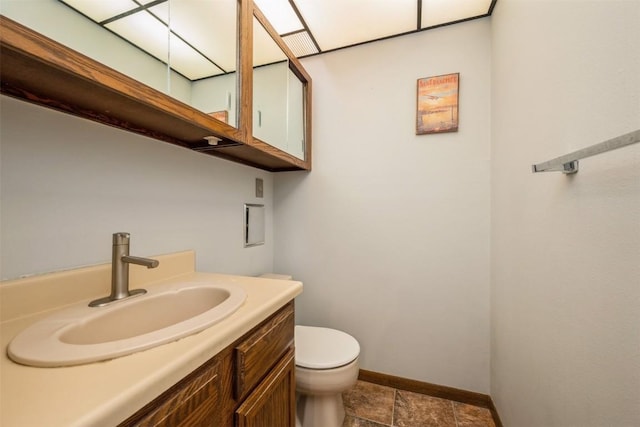 bathroom featuring toilet and vanity