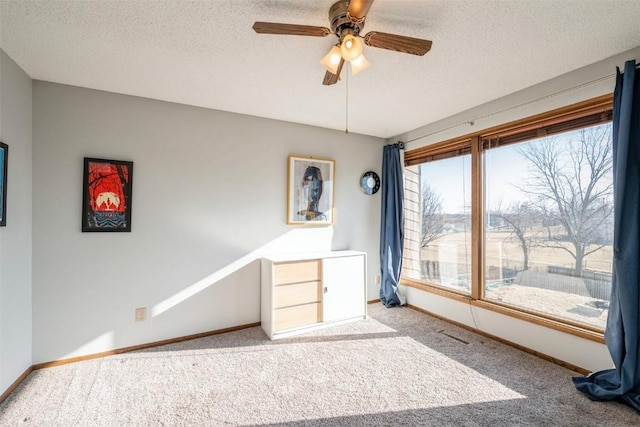 interior space featuring ceiling fan and a textured ceiling