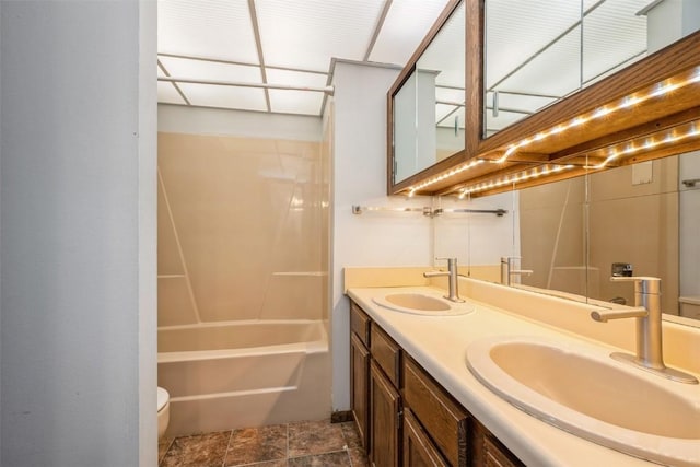 full bathroom with toilet, vanity, and shower / washtub combination