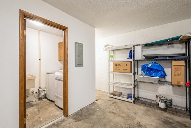 storage area featuring washing machine and dryer and electric panel