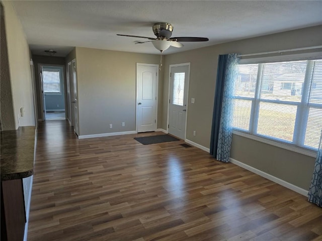 entryway featuring dark wood-type flooring and ceiling fan