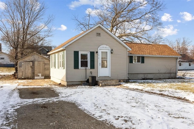 bungalow featuring a shed