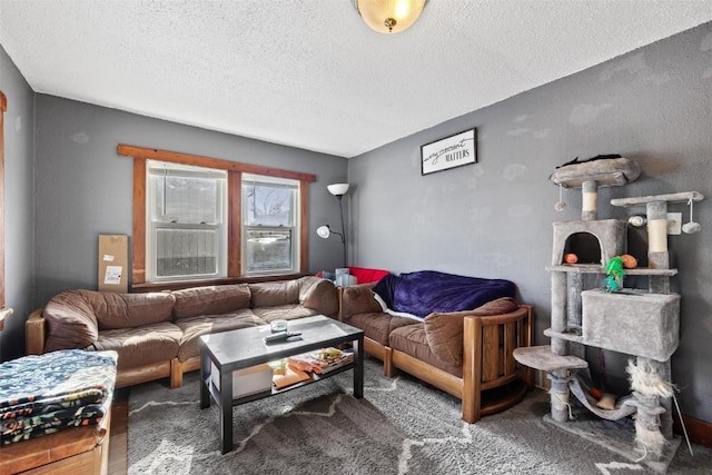 carpeted living room featuring a textured ceiling