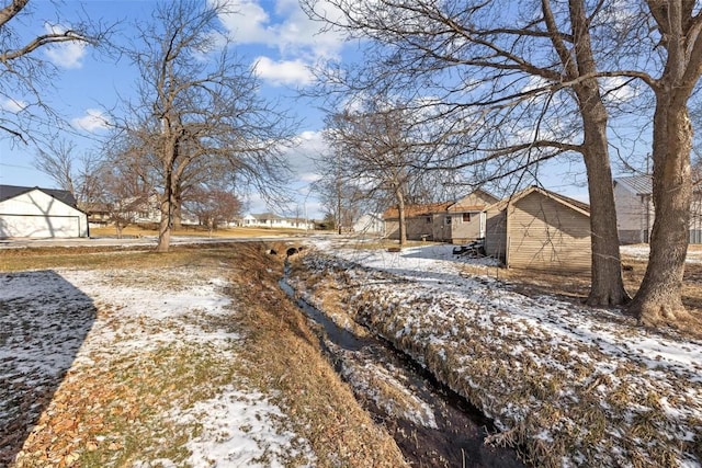 view of yard layered in snow