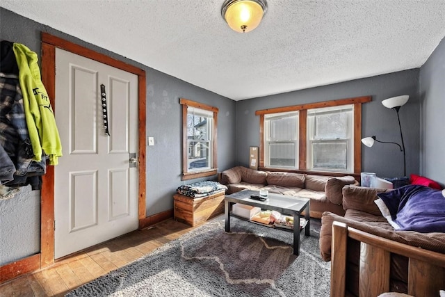 living room with a textured ceiling and hardwood / wood-style flooring