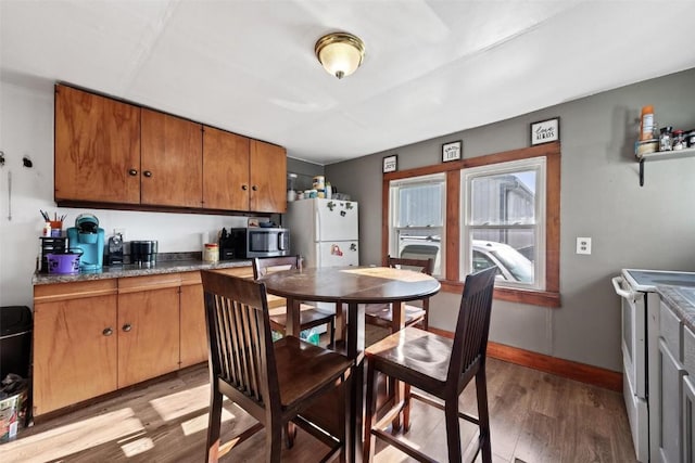 kitchen featuring light hardwood / wood-style flooring and white appliances