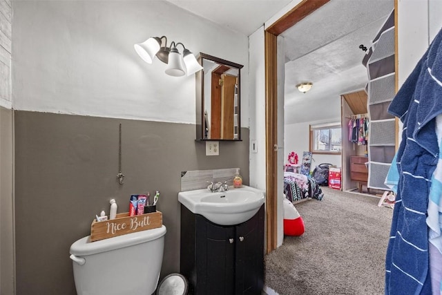 bathroom with toilet and vanity