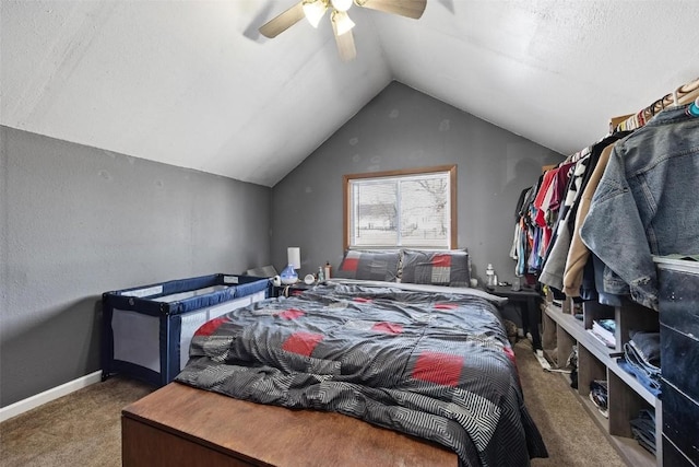 carpeted bedroom with ceiling fan and vaulted ceiling