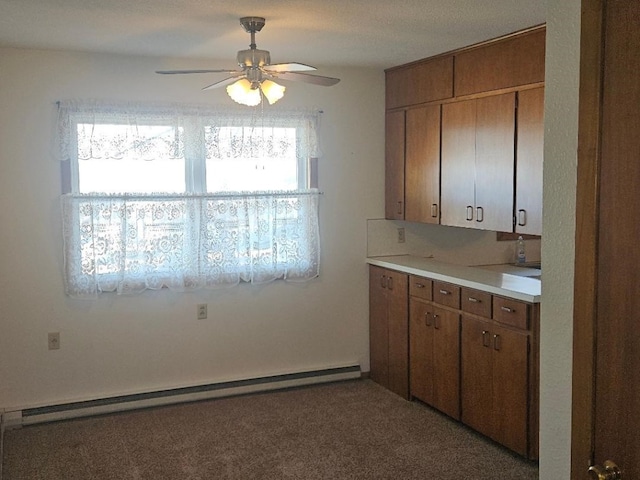 kitchen featuring decorative backsplash, a baseboard radiator, a wealth of natural light, and ceiling fan