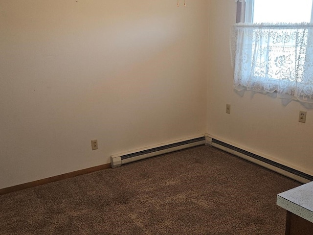 spare room with baseboard heating and carpet flooring