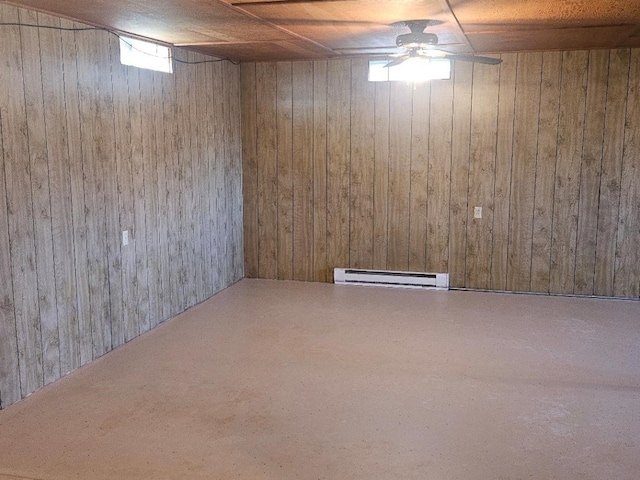 basement with baseboard heating and wood walls