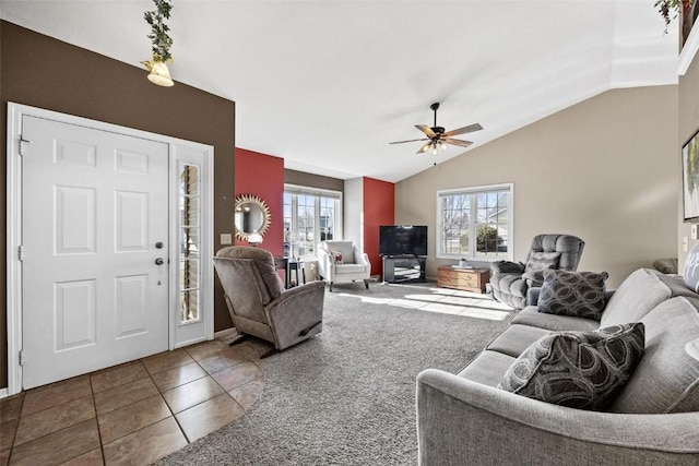 living room featuring ceiling fan, lofted ceiling, and tile patterned floors