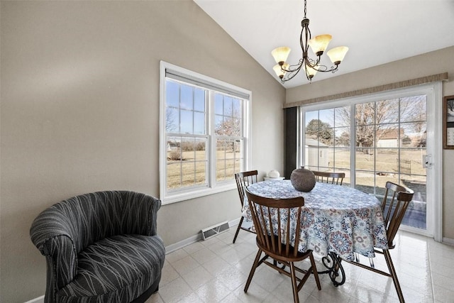 dining space featuring vaulted ceiling and a chandelier