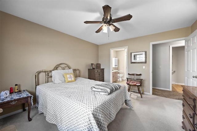 bedroom featuring ceiling fan, ensuite bath, and carpet flooring