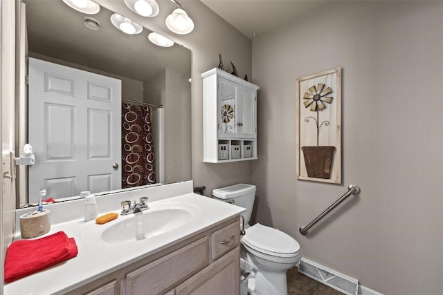 bathroom with toilet, vanity, and a shower with curtain