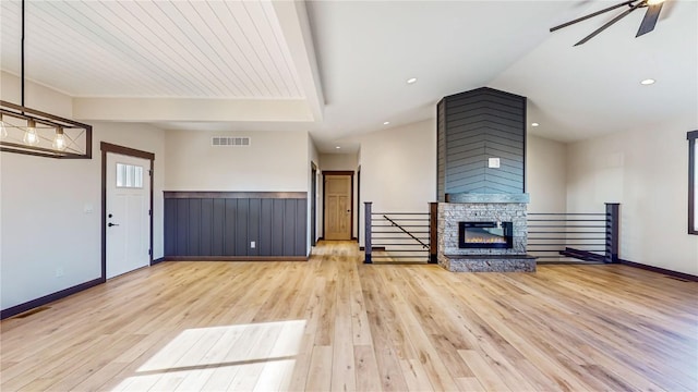 unfurnished living room featuring recessed lighting, visible vents, a ceiling fan, a stone fireplace, and wood finished floors