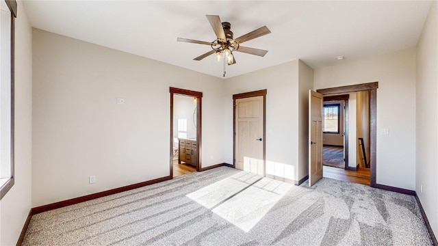 unfurnished bedroom featuring ceiling fan, light colored carpet, and connected bathroom