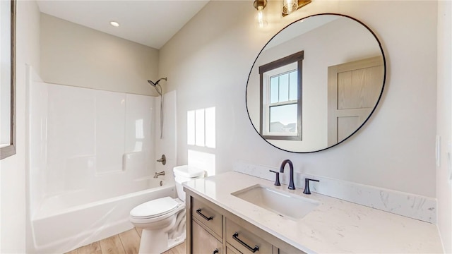 full bathroom featuring wood-type flooring, shower / bathing tub combination, vanity, and toilet