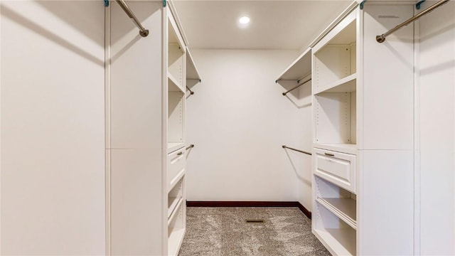 walk in closet with carpet