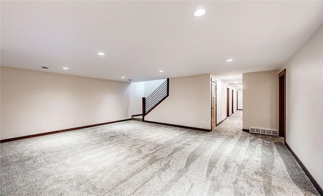 interior space with light carpet, stairs, visible vents, and recessed lighting