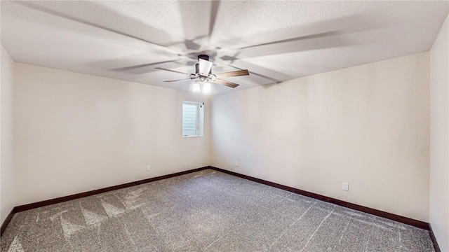 carpeted empty room featuring a textured ceiling, baseboards, and ceiling fan