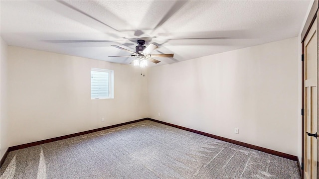 empty room with ceiling fan, a textured ceiling, and carpet flooring