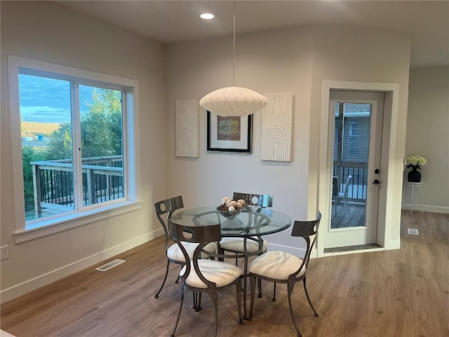 dining area with hardwood / wood-style floors