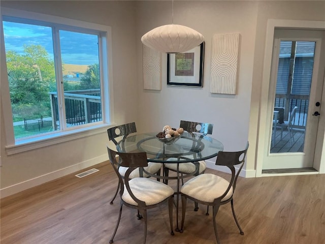 dining space with hardwood / wood-style flooring