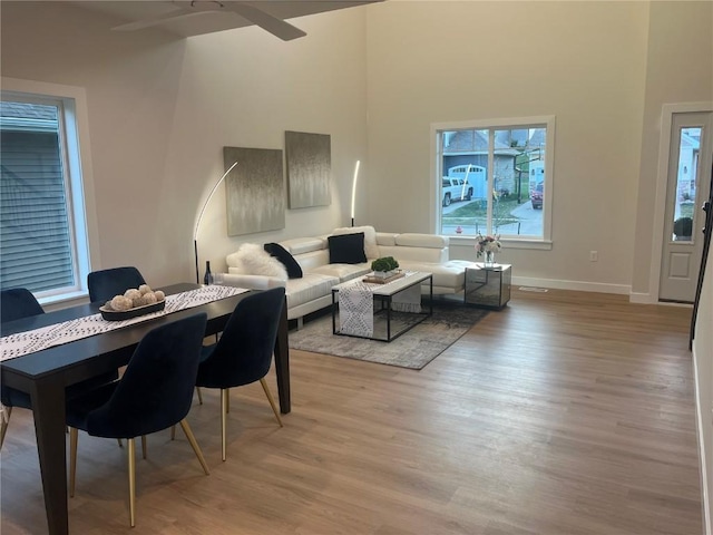 dining space featuring light wood-type flooring and ceiling fan