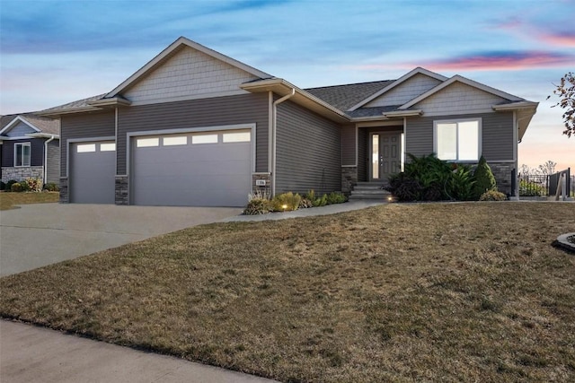 craftsman-style home with a garage and a lawn