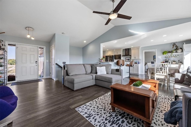 living room featuring vaulted ceiling, ceiling fan, and dark wood-type flooring