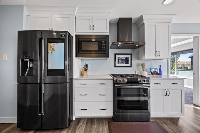 kitchen with white cabinetry, wall chimney range hood, range with two ovens, fridge with ice dispenser, and built in microwave