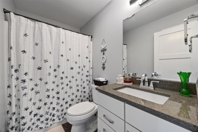 bathroom featuring vanity, toilet, and a shower with shower curtain