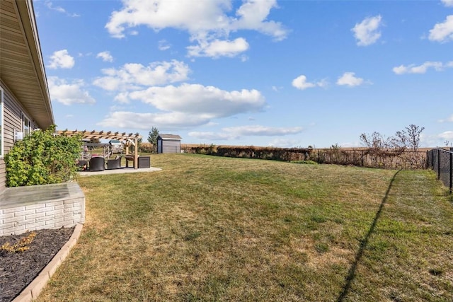 view of yard featuring a patio, a pergola, and a storage shed