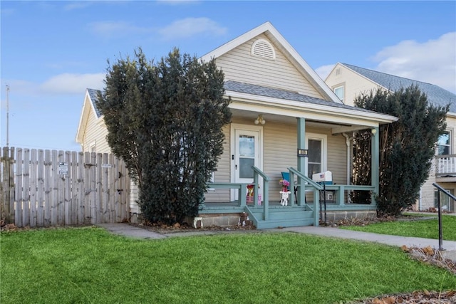 view of front facade with covered porch and a front yard