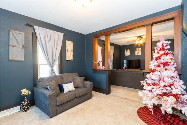 carpeted living room featuring ceiling fan