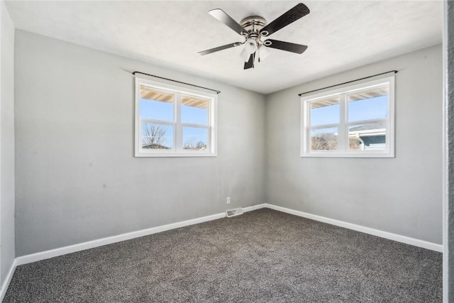 spare room featuring ceiling fan and carpet floors