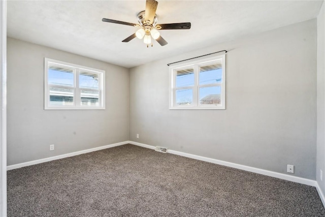 empty room featuring carpet floors and ceiling fan