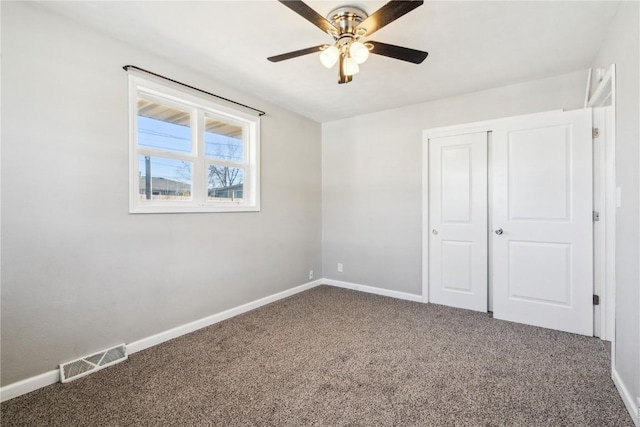 unfurnished bedroom featuring a closet, ceiling fan, and carpet flooring