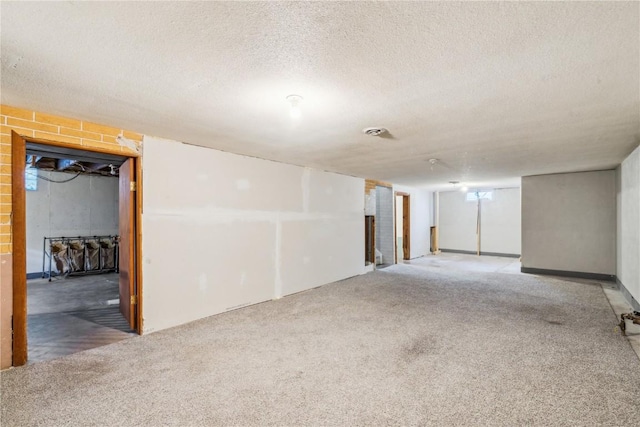 basement featuring a textured ceiling and carpet floors