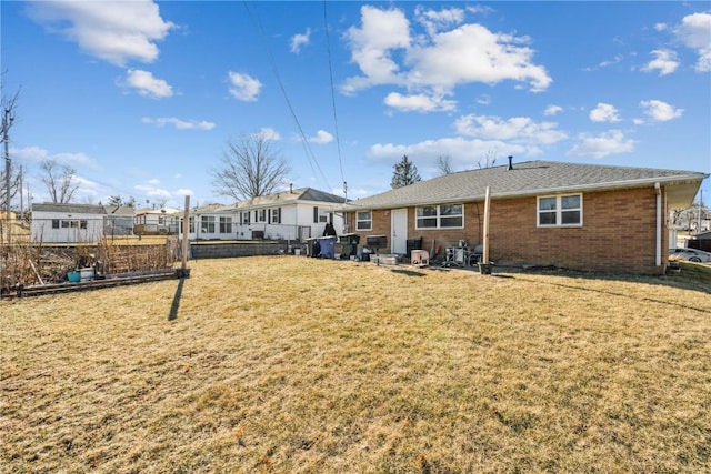 rear view of house featuring a yard