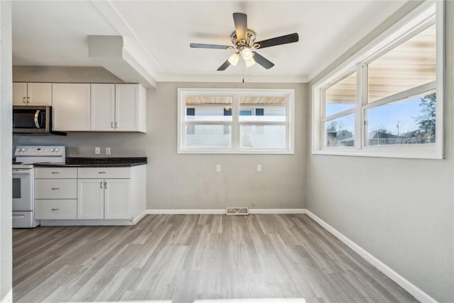 kitchen with crown molding, ceiling fan, white cabinetry, light hardwood / wood-style floors, and white electric stove