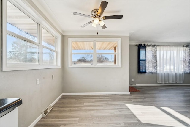 interior space with ceiling fan, hardwood / wood-style floors, and crown molding